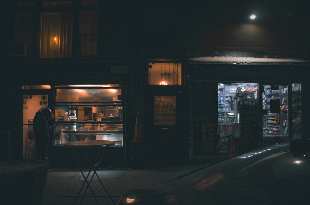 Storefronts after dark — photograph by Tony Powers