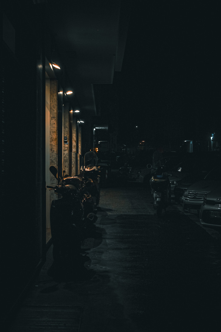 A narrow street at night — photograph by Tony Powers