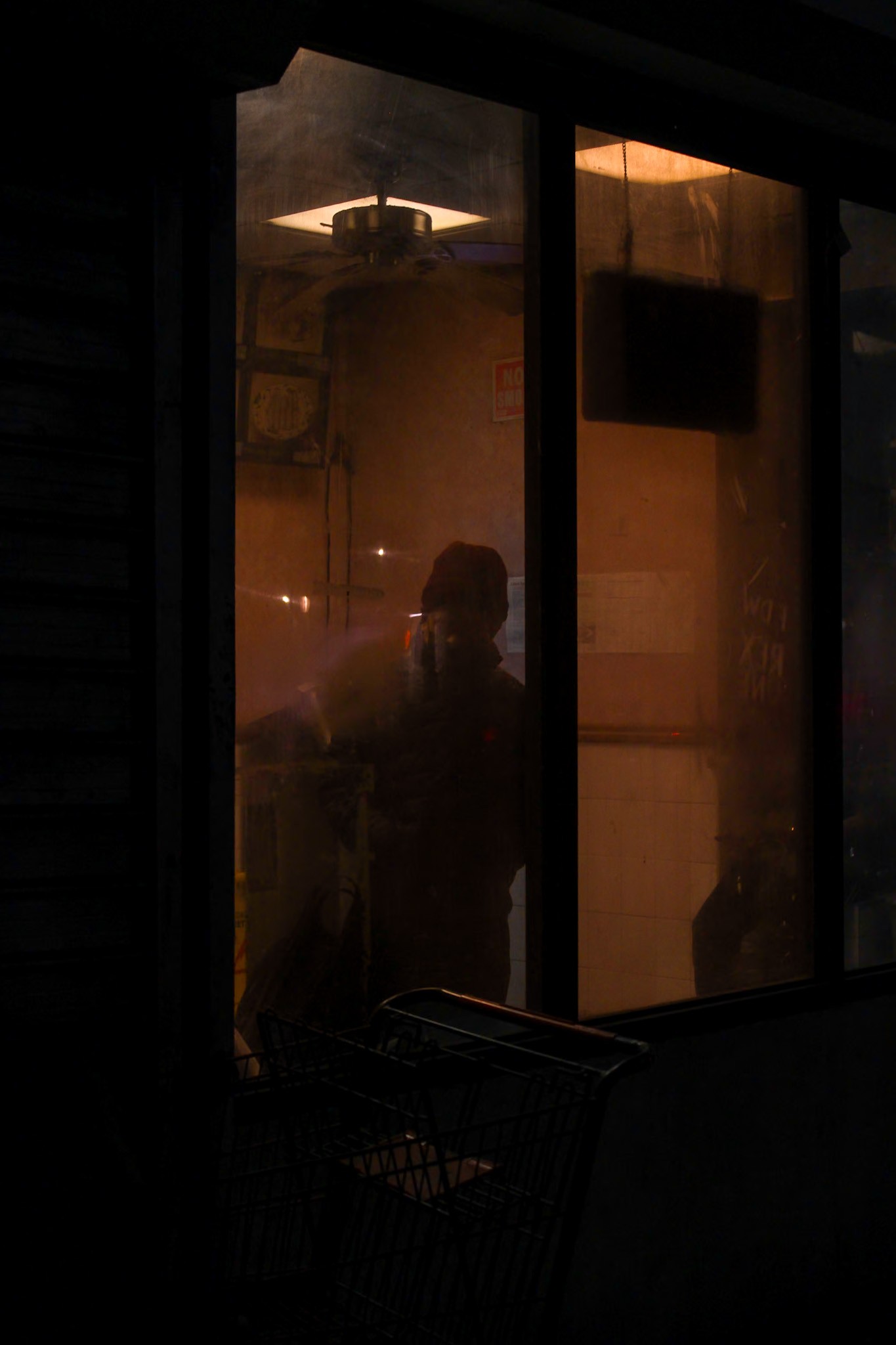 Amber light in a storefront — photograph by Tony Powers