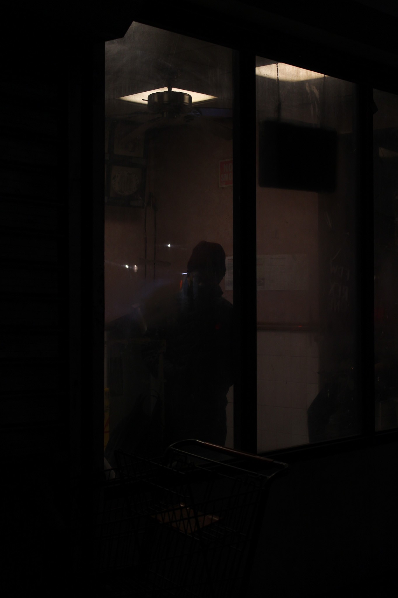A storefront in shadow — photograph by Tony Powers
